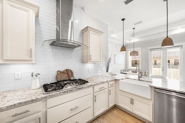 a kitchen with granite countertop a sink a counter top space and living room view