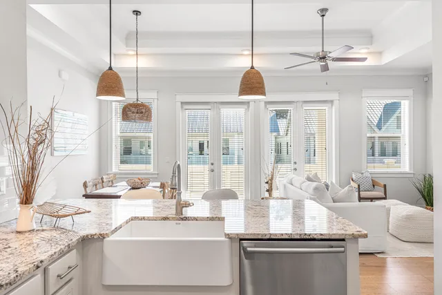 a kitchen with stainless steel appliances granite countertop a sink refrigerator and cabinets