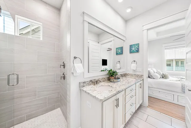 a bedroom with a bed a flat screen tv and a large window