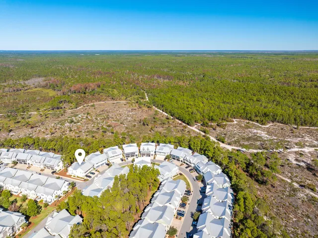 a view of a house with swimming pool and sitting area