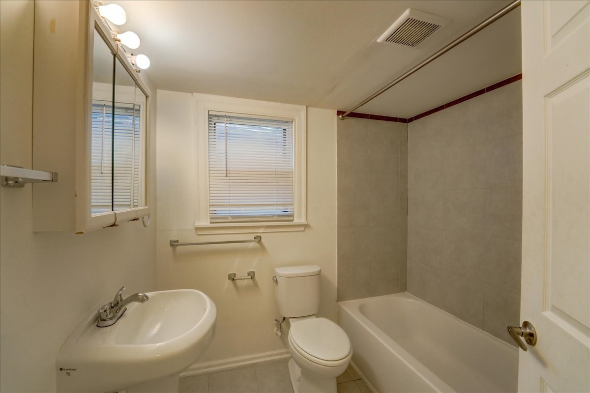 1105 East 3rd Street Austin, TX 78702 - Photo 14 of 40 a bathroom with a sink toilet and shower