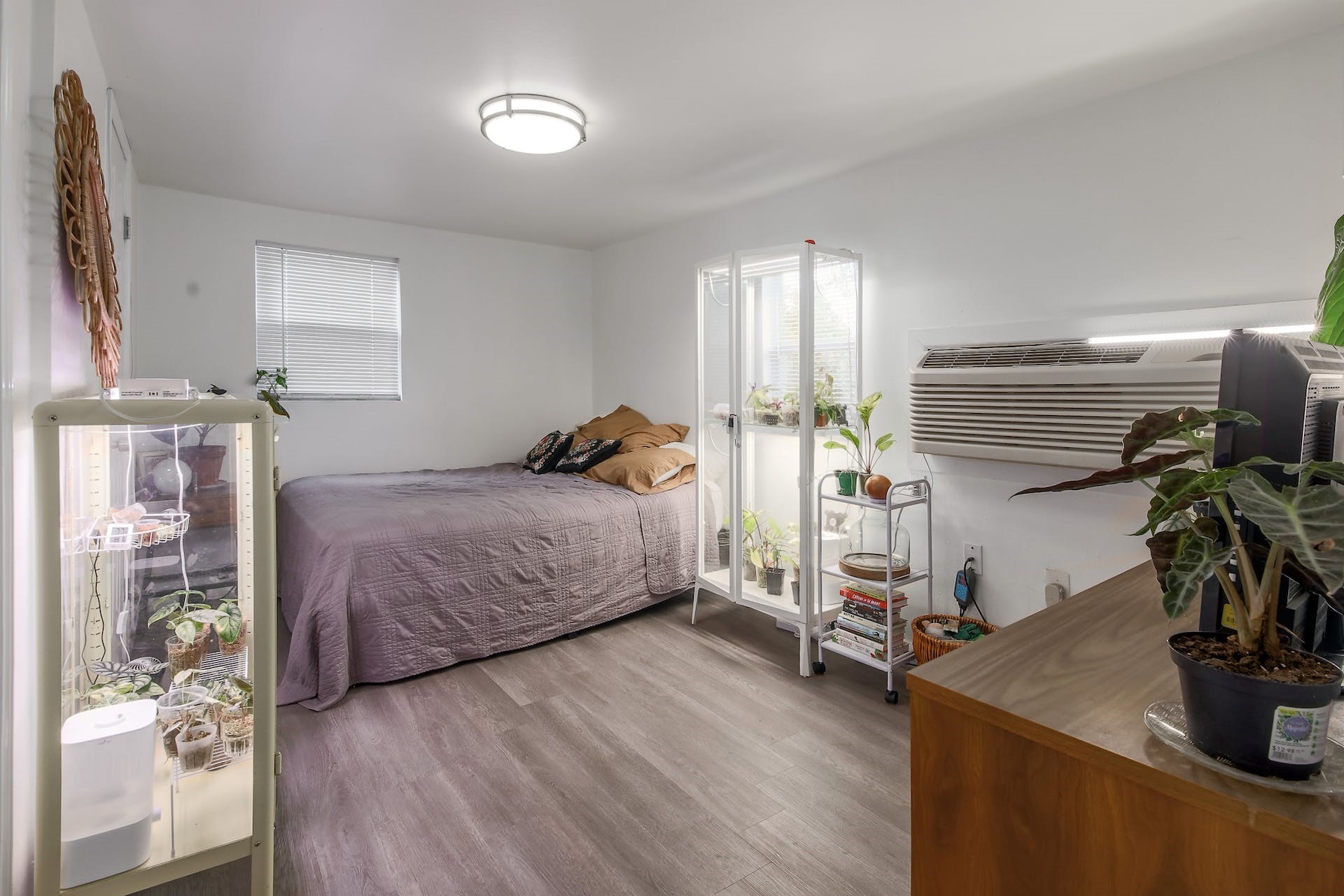 1105 East 3rd Street Austin, TX 78702 - Photo 25 of 40 a bedroom with a bed and wooden floor