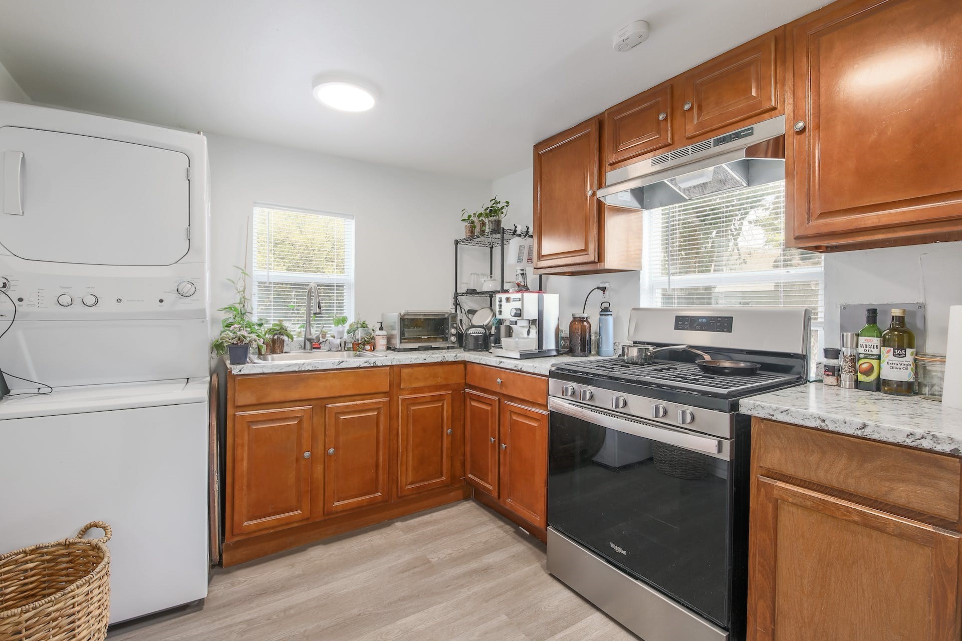 1105 East 3rd Street Austin, TX 78702 - Photo 29 of 40 a kitchen with stainless steel appliances granite countertop a stove a sink and a refrigerator