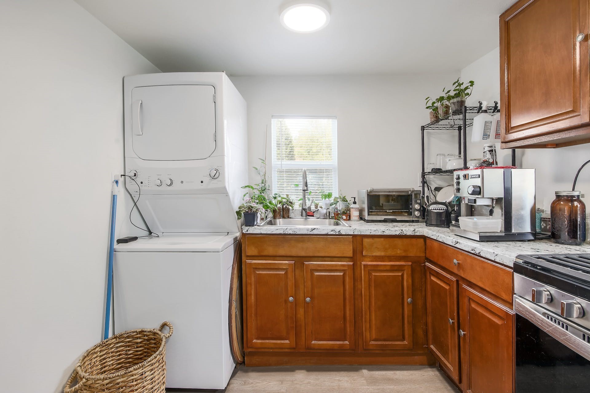 1105 East 3rd Street Austin, TX 78702 - Photo 30 of 40 a kitchen with stainless steel appliances granite countertop a sink stove and cabinets