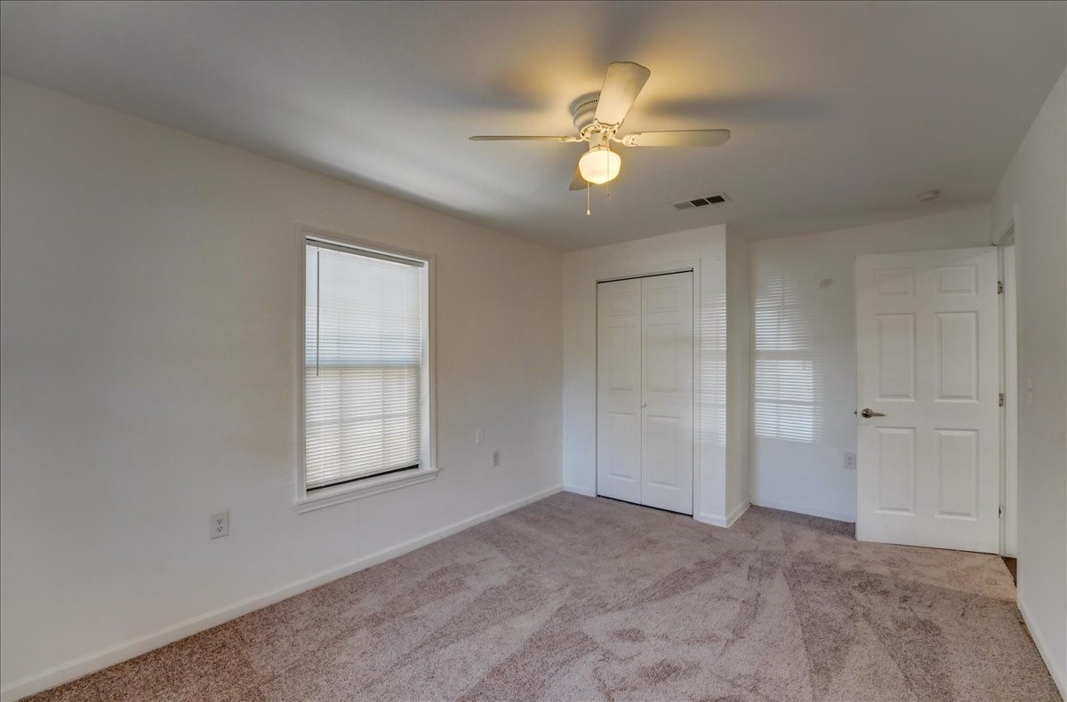 1105 East 3rd Street Austin, TX 78702 - Photo 10 of 40 an empty room with windows and fan