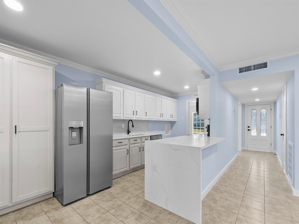 2033 Lymington Road Carrollton, TX 75007 - Photo 6 of 33 White cabinetry, light-toned tile flooring, recessed lighting, and a white entry door with decorative glass