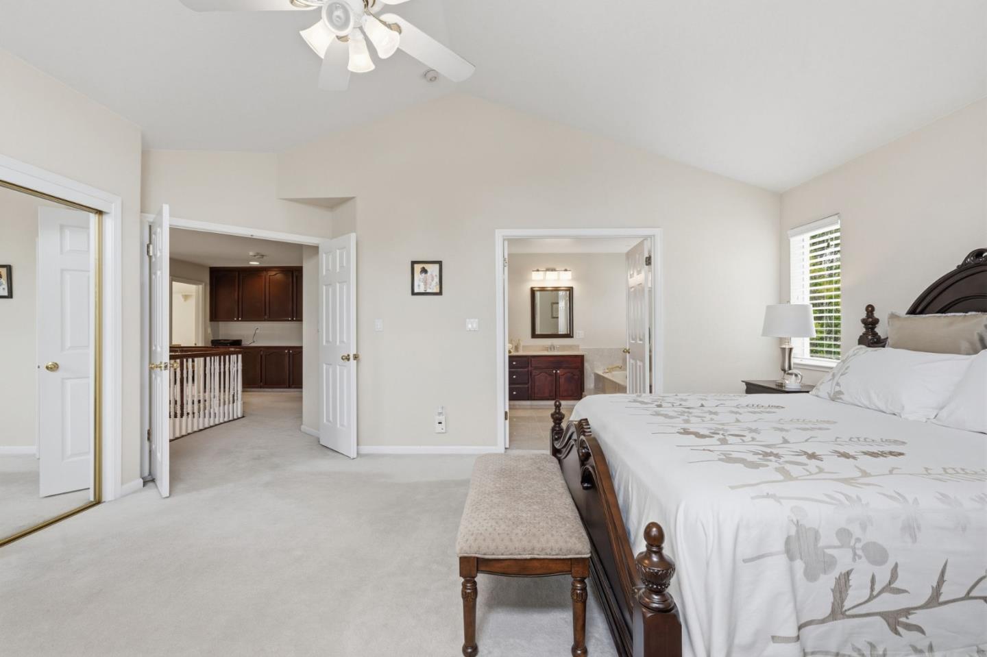 35 Sierra Ridge Court Danville, CA 94506 - Photo 22 of 37 a spacious bedroom with a bed and a chandelier