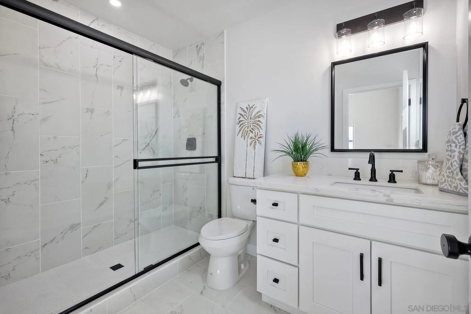 573 Florida Street Imperial Beach, CA 91932 - Photo 18 of 37 a bathroom with a granite countertop sink a toilet and a mirror