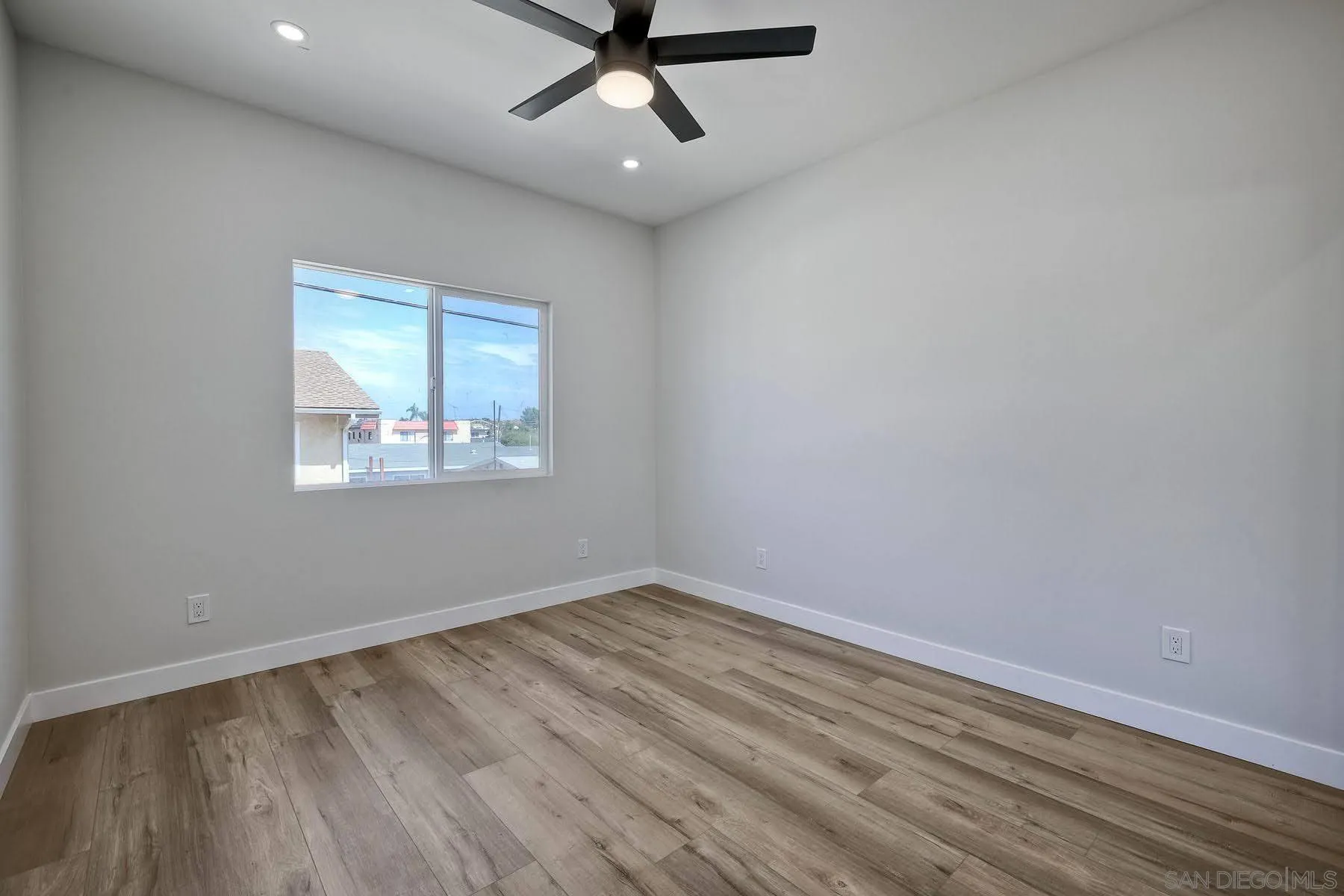 573 Florida Street Imperial Beach, CA 91932 - Photo 19 of 37 an empty room with wooden floor ceiling fan and windows