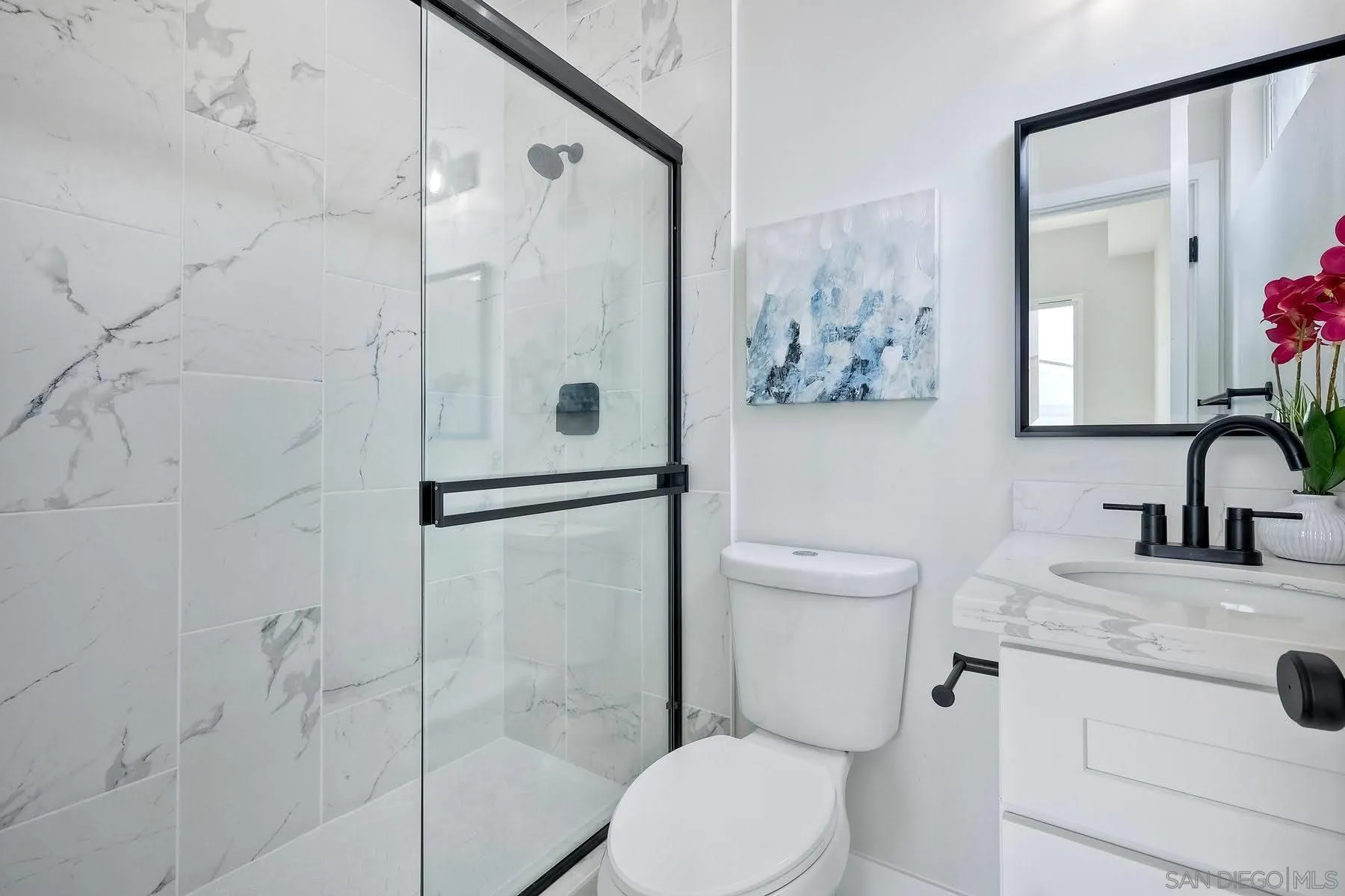 573 Florida Street Imperial Beach, CA 91932 - Photo 29 of 37 a bathroom with a granite countertop toilet sink and shower