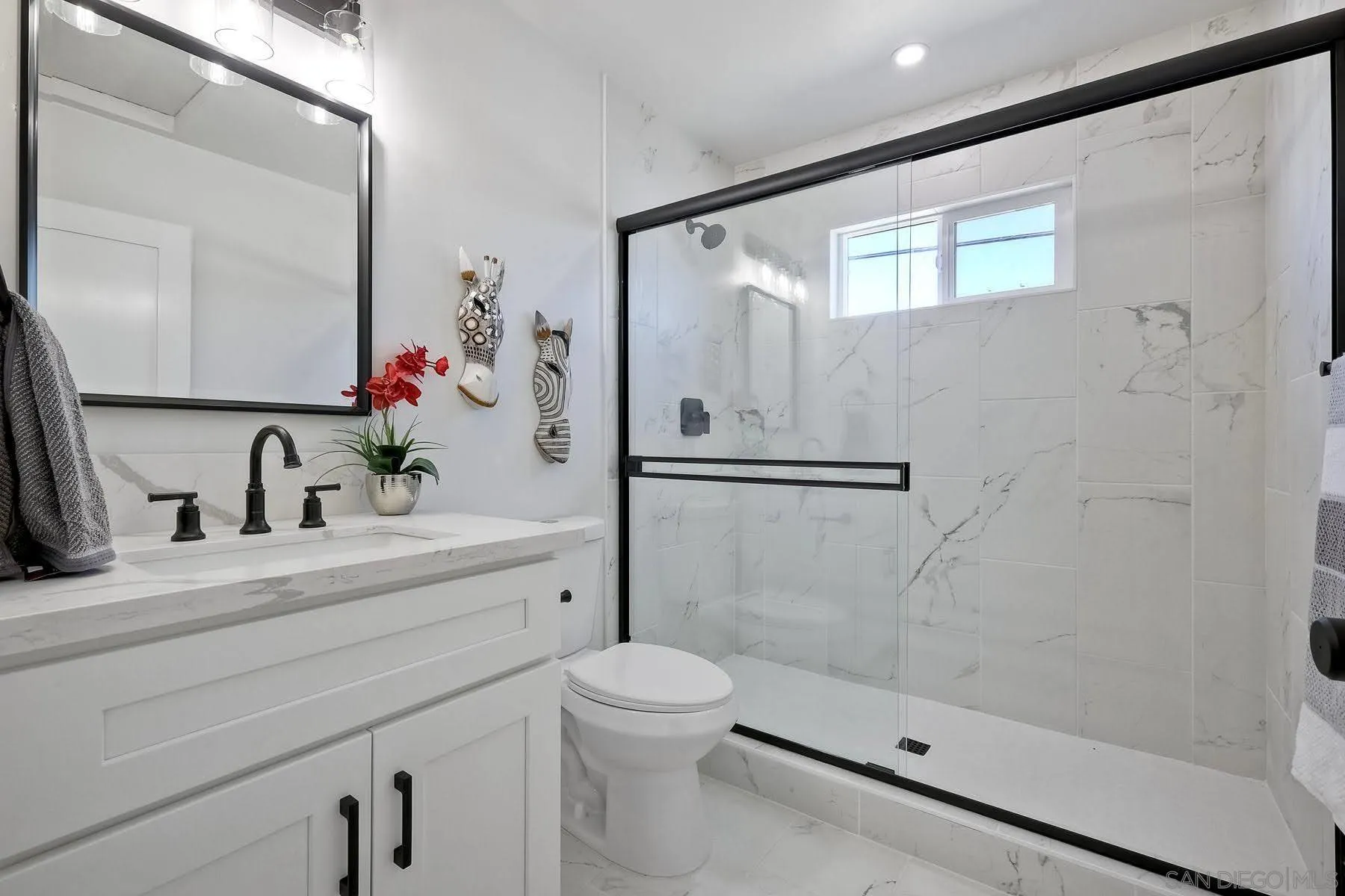 573 Florida Street Imperial Beach, CA 91932 - Photo 9 of 37 a bathroom with a shower sink vanity mirror and toilet