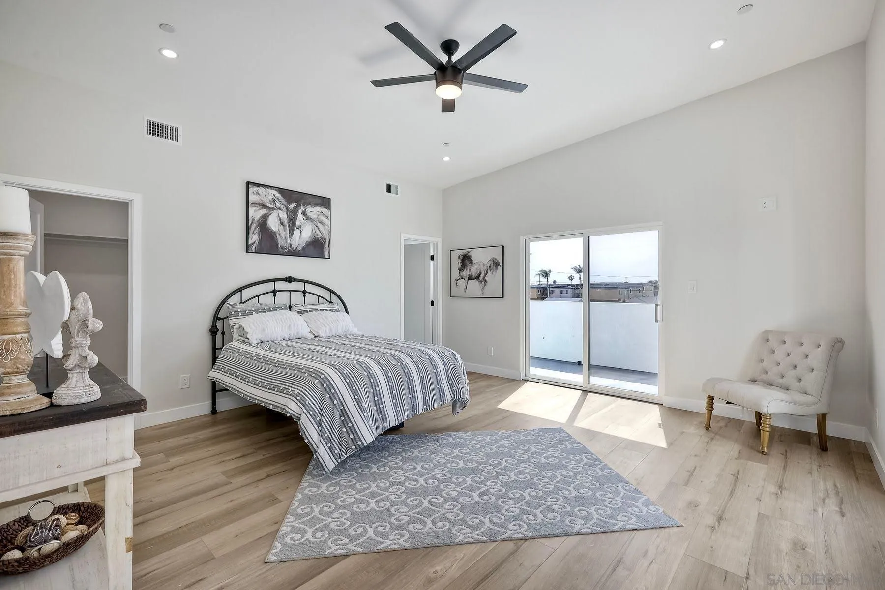 573 Florida Street Imperial Beach, CA 91932 - Photo 10 of 37 a bedroom with a bed and glass walk in closet