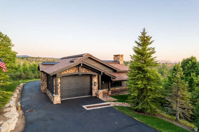 9156 Forest Road, Unit 24 Heber City, UT 84036 - Photo 34 of 42 Craftsman-style home featuring a stone and wood exterior with a dark asphalt driveway