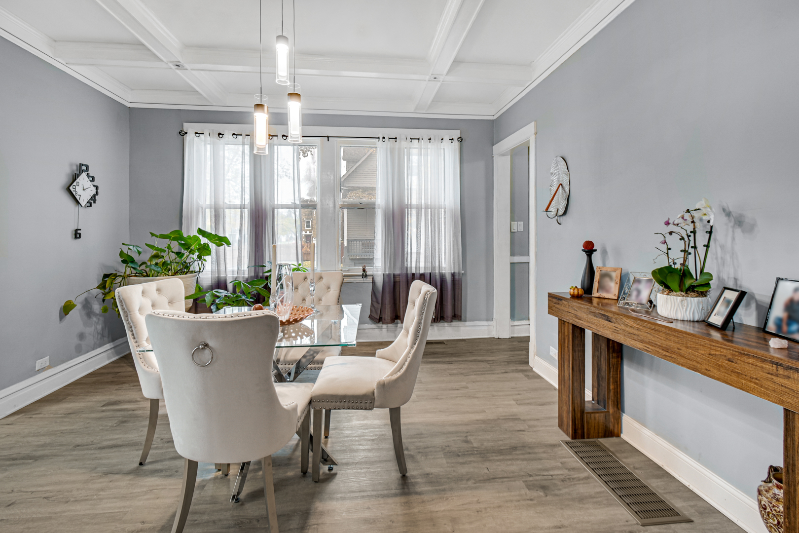 11548 South Normal Avenue Chicago, IL 60628 - Photo 11 of 21 a dining room with furniture potted plants and wooden floor