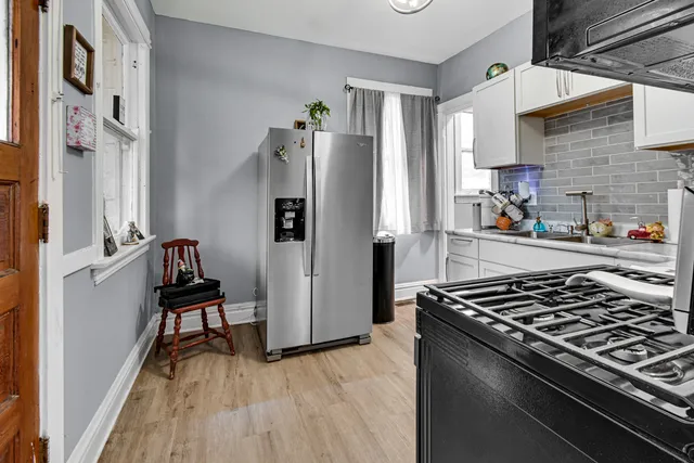a kitchen with stainless steel appliances granite countertop a stove and a refrigerator