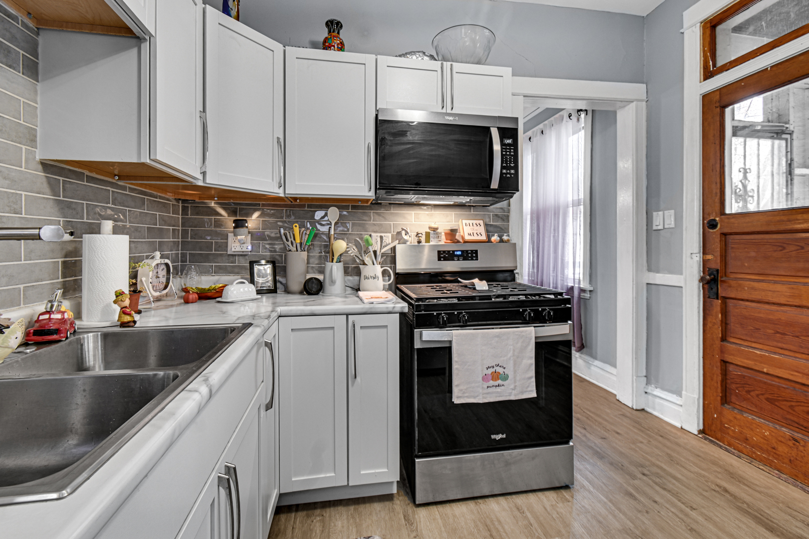 11548 South Normal Avenue Chicago, IL 60628 - Photo 14 of 21 a kitchen with a sink stove and microwave