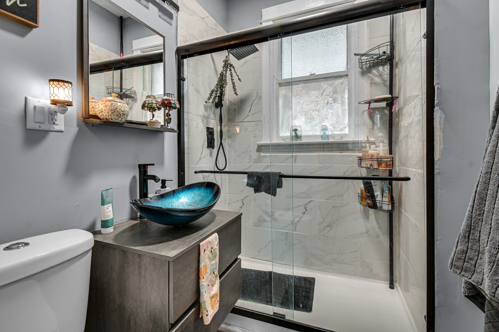 11548 South Normal Avenue Chicago, IL 60628 - Photo 17 of 21 a bathroom with a granite countertop sink a mirror and shower