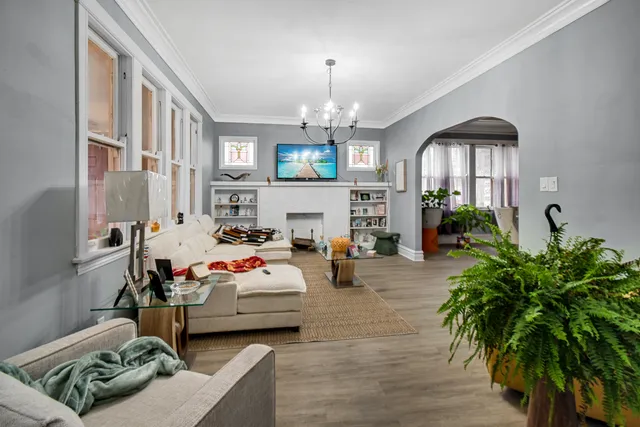 a living room with furniture fireplace and a window