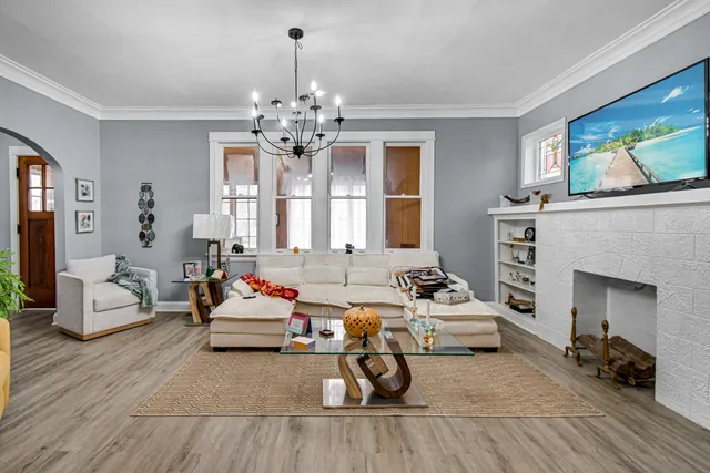 a living room with furniture a fireplace and a flat screen tv