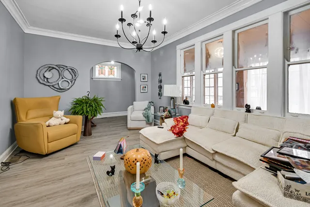 a living room with furniture and a chandelier