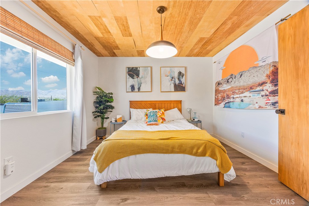 6123 Scenic Drive Joshua Tree, CA 92252 - Photo 12 of 30 a bedroom with a bed and a large window with outer view