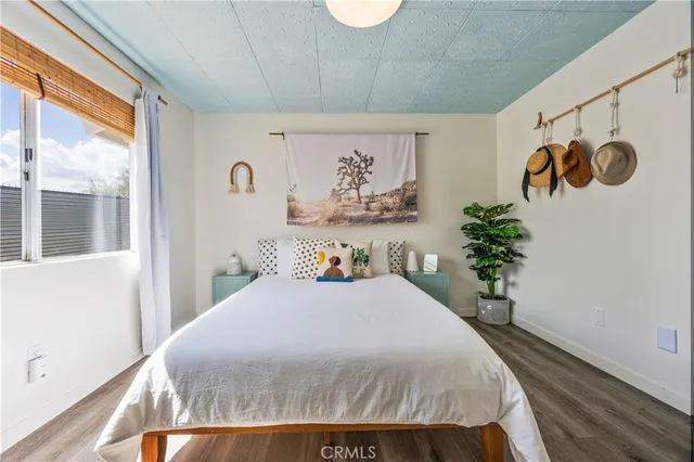 a bedroom with a large bed and a potted plant