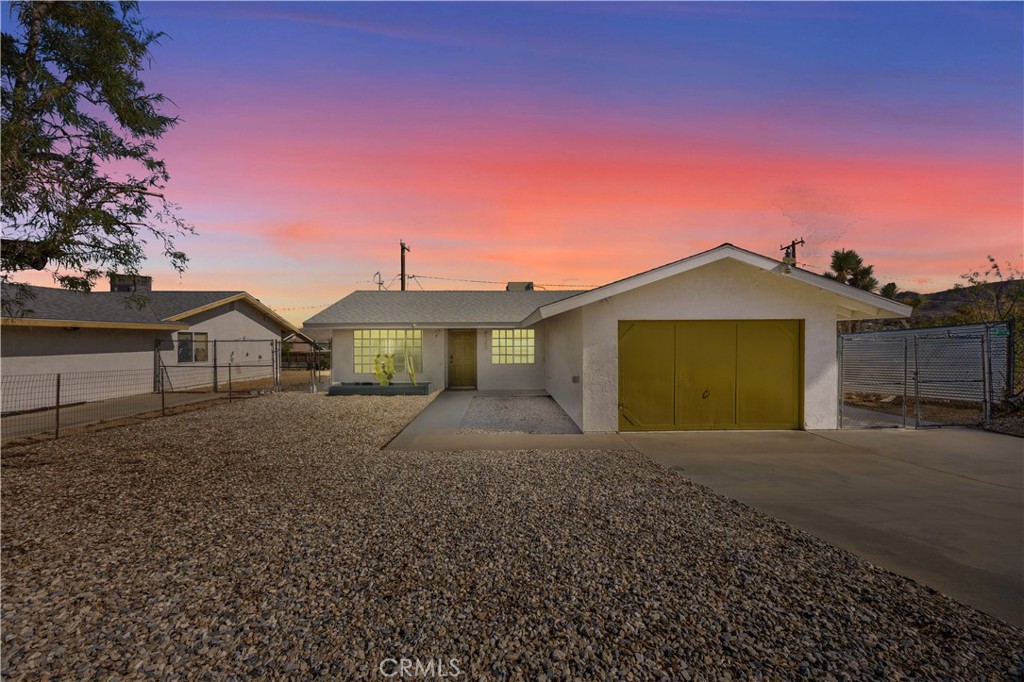 6123 Scenic Drive Joshua Tree, CA 92252 - Photo 2 of 30 a front view of a house with a yard and garage