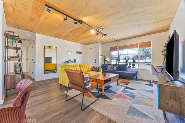 a living room with dining room and wooden floor