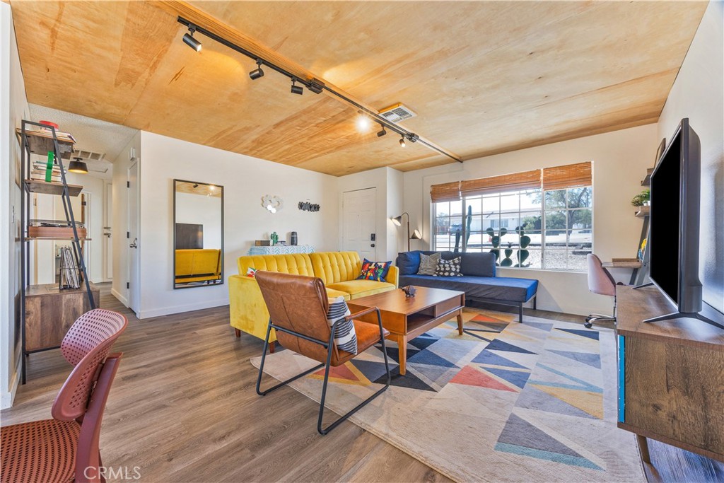 6123 Scenic Drive Joshua Tree, CA 92252 - Photo 5 of 30 a living room with dining room and wooden floor