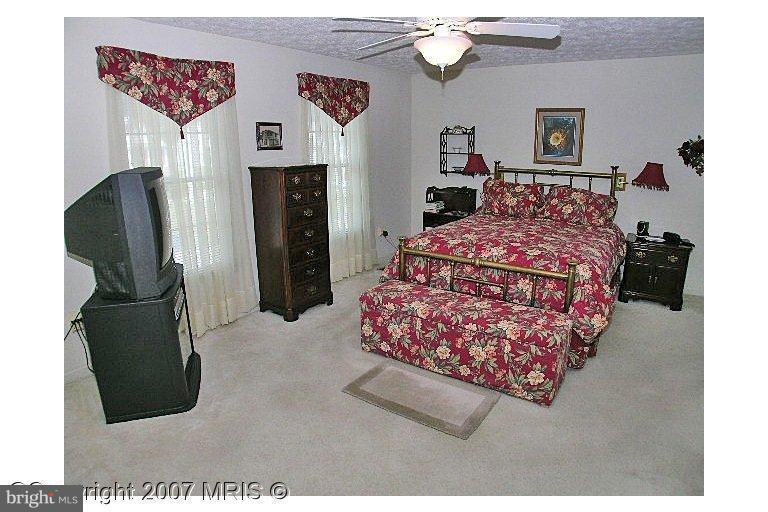 a bedroom with a bed and a large mirror