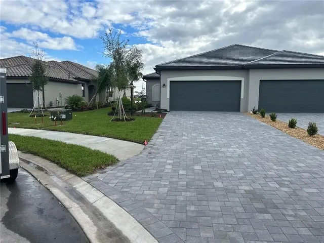 a front view of a house with a yard and garage