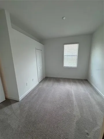 an empty room with a empty space and windows