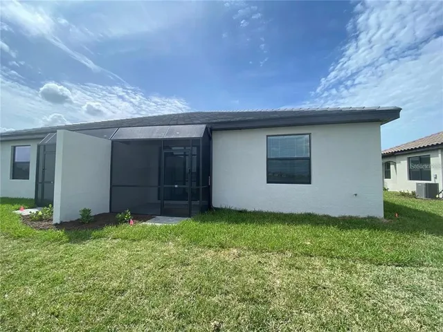 a view of a house with a yard and garage