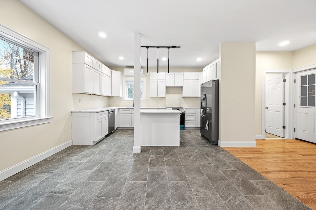 10 Beale Street Worcester, MA 01606 - Photo 11 of 42 a kitchen with stainless steel appliances a refrigerator sink and cabinets
