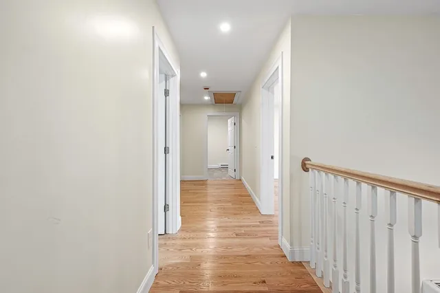a view of a hallway with wooden floor