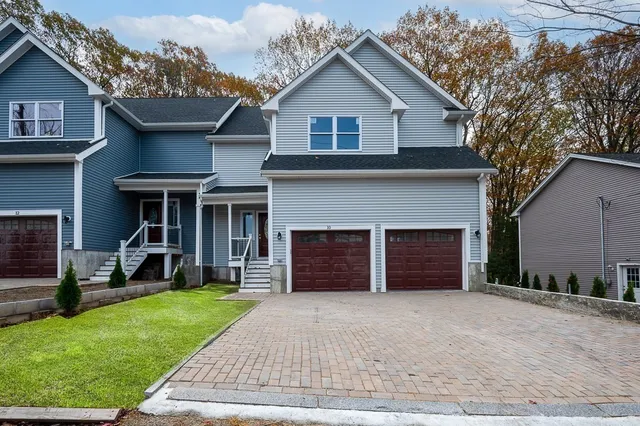 a front view of a house with a yard and garage