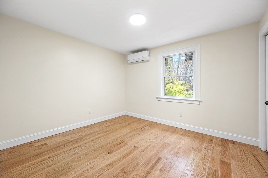 10 Beale Street Worcester, MA 01606 - Photo 24 of 42 an empty room with wooden floor and windows