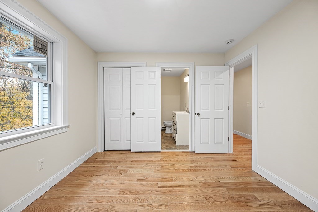 10 Beale Street Worcester, MA 01606 - Photo 25 of 42 a view of empty room with wooden floor and windows
