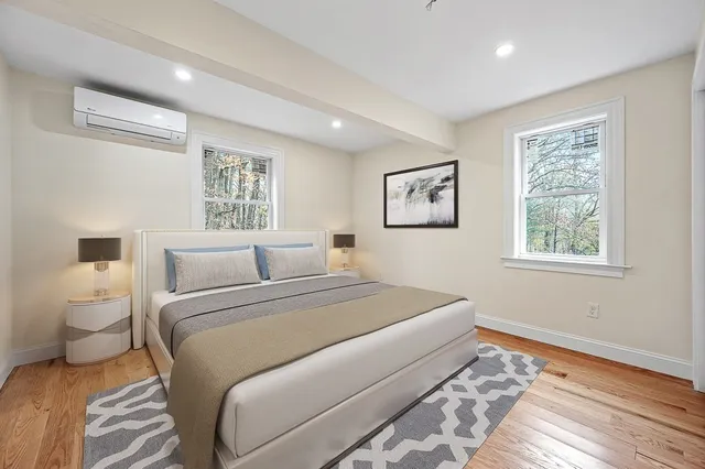 a bedroom with a large bed and a window