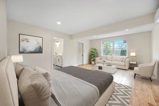 a spacious bedroom with a bed and glass window