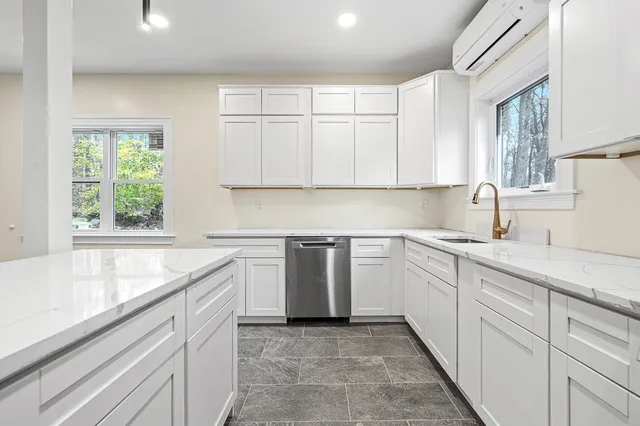 a kitchen with a sink stove and cabinets