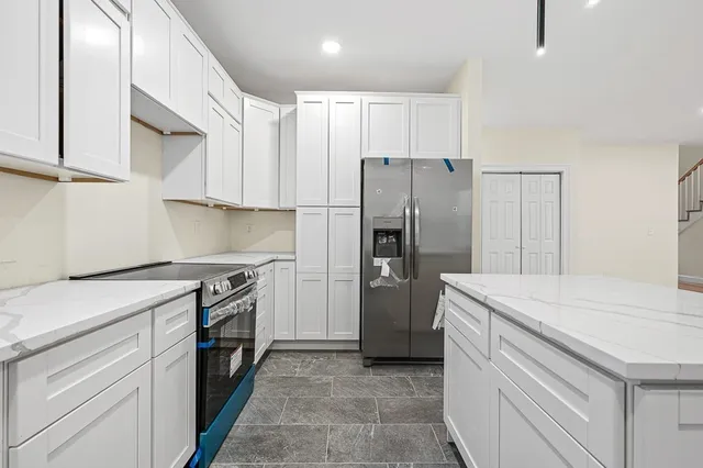 a kitchen with a stove a sink and a refrigerator
