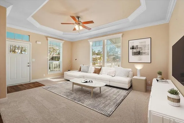 a living room with furniture a chandelier and a window