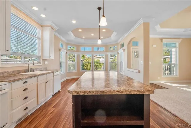 a kitchen with sink stove and granite counter top