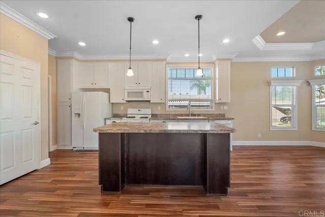 a view of kitchen with granite countertop cabinets and wooden floor