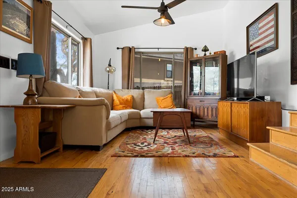 a living room with furniture and a wooden floor