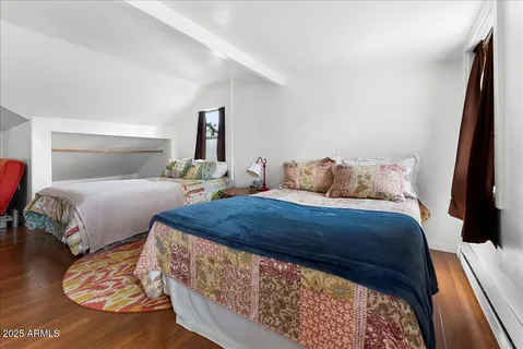 a bedroom with two beds and a night stand