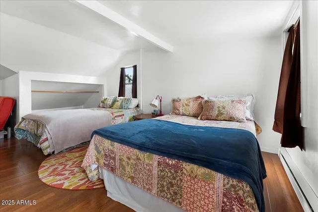 a bedroom with two beds and a night stand