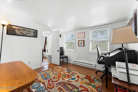 a bedroom with furniture and a window