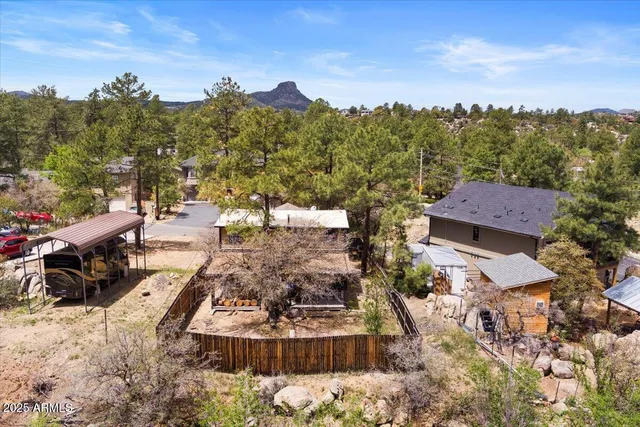 an aerial view of a house with a yard basket ball court and outdoor seating
